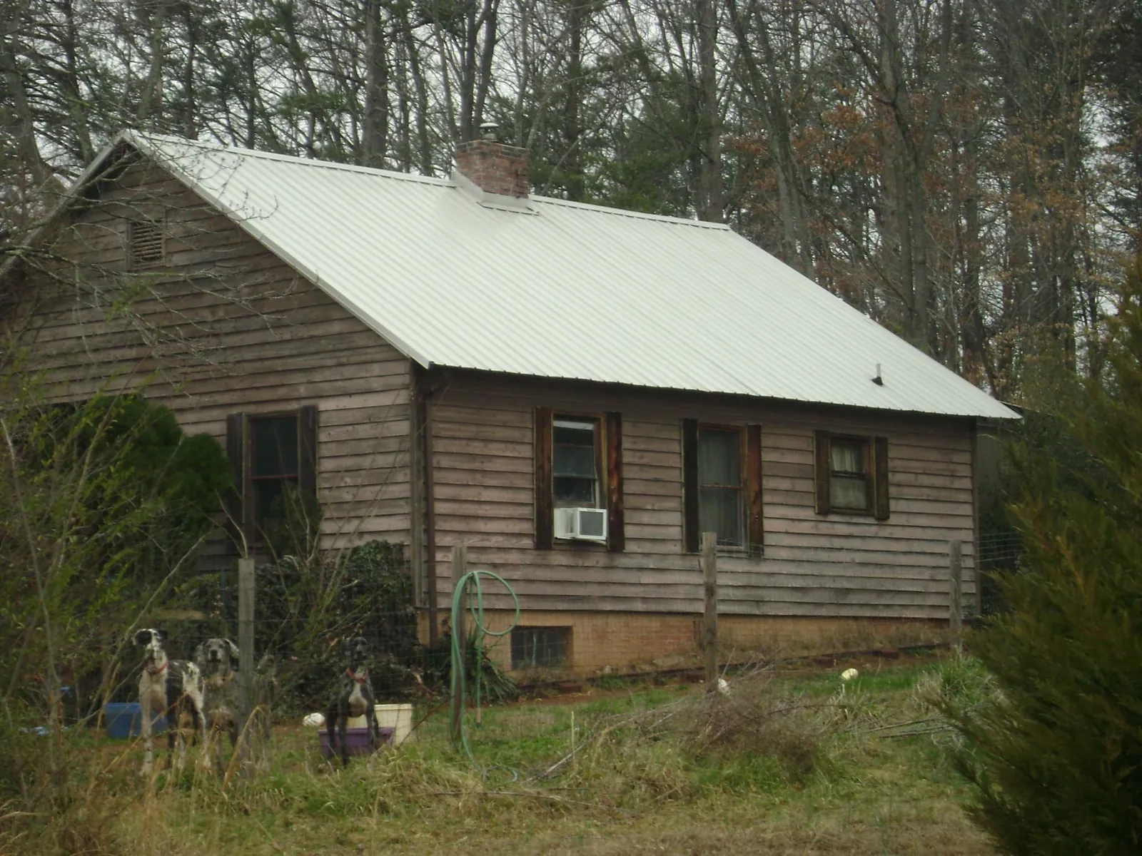 White metal roof on an old wood sided farmhouse, from a Metal Roof Installation job in Shamokin Dam